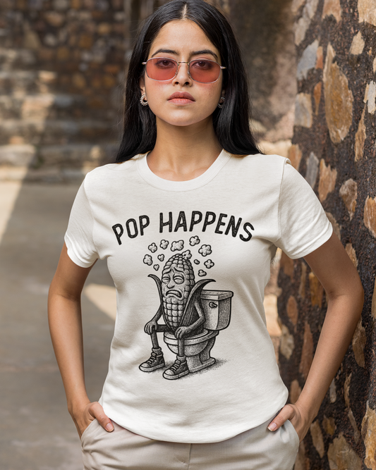 Woman wearing a white t-shirt with 'Pop Happens' graphic design outdoors.